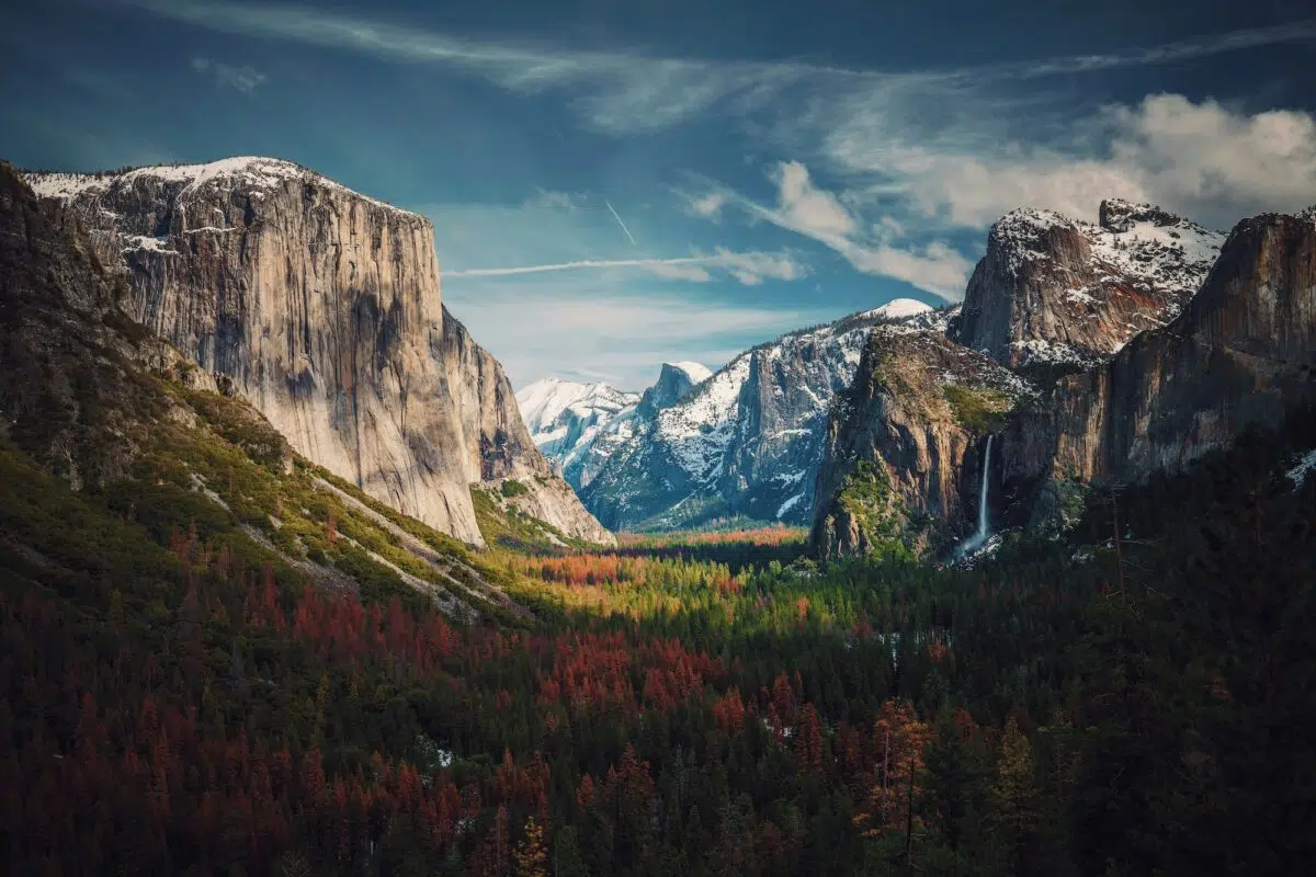 Vallée de montagne aux falaises de granit et forêt aux couleurs d'automne
